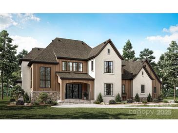 Beautiful two-story home with a stone foundation, wood accents, and a welcoming front porch at 105 Redbird Ln, Weddington, NC 28104
