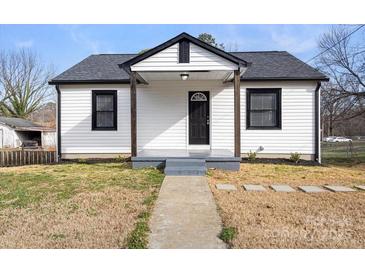 Charming house with a classic black and white color scheme and a well-maintained front yard at 1110 Alexander St, Statesville, NC 28677