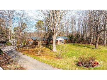 Charming one-story brick home with a well-manicured lawn and mature trees at 6000 George Hildebran School Rd, Hickory, NC 28602