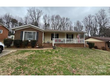 Charming single-story home featuring a cozy front porch and brick accents at 8522 Stonehurst Dr, Charlotte, NC 28214