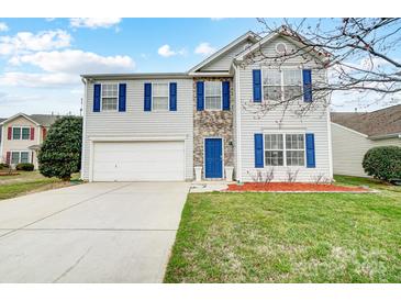 Charming two-story home with a two car garage, blue shutters and stone accents at 1022 Southwind Trail Dr, Indian Trail, NC 28079