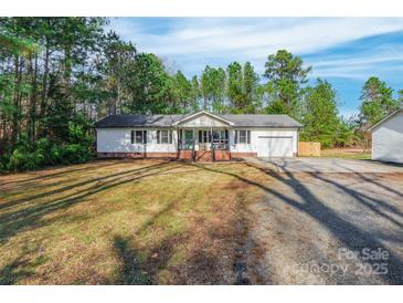 Charming single story home with white siding, attached garage, and a well-maintained front yard at 113 Tanager Dr, York, SC 29745