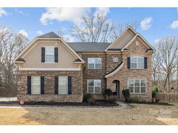 Charming two-story brick and siding home with a manicured lawn and lovely curb appeal at 12515 Hashanli Pl, Matthews, NC 28105