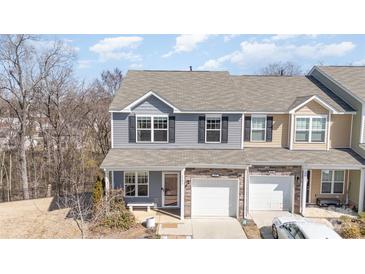 Charming two-story townhome with stone accents and attached one car garage at 6503 Revolutionary Trl, Charlotte, NC 28217