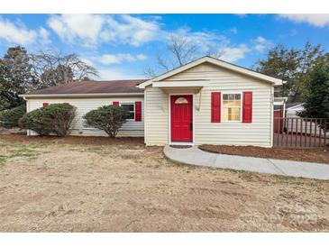 Charming single-story home with a red door and shutters, complemented by a well-maintained front yard at 717 Perth Rd, Troutman, NC 28166