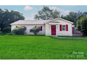 Charming one-story home with a bright red front door, shutters, and a well-manicured lawn at 717 Perth Rd, Troutman, NC 28166