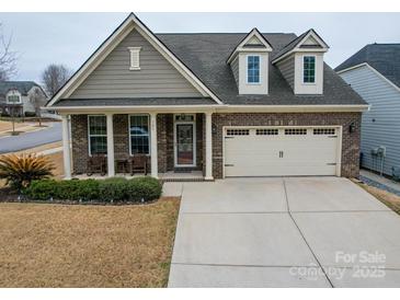 Charming single-Gathering home with a brick front, columns, dormers and a two-car garage at 105 Blossom Ridge Dr, Mooresville, NC 28117