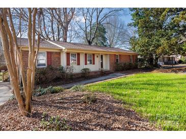 Charming single-story brick home with a well-maintained lawn and traditional architectural details at 1825 Hyatt Ave, Rock Hill, SC 29732