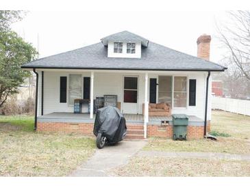 Charming single-story home with a cozy front porch and a well-maintained brick foundation at 2204 W Second Ave, Gastonia, NC 28052