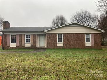 Charming single-story brick home featuring cozy curb appeal and an inviting front yard at 3003 Winston Nw Dr, Concord, NC 28027