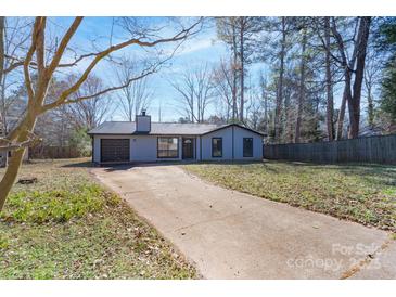 Charming one-story home with a gray exterior and a long, private driveway at 7209 Tressel Ln, Mint Hill, NC 28227