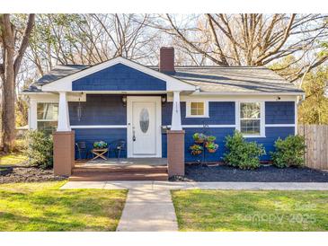 Charming home with a covered front porch and well-maintained landscaping at 119 N Smallwood Pl, Charlotte, NC 28216