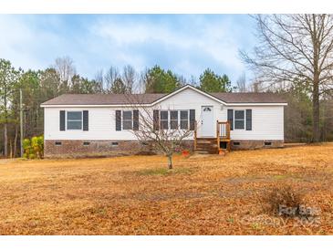 Charming one-story home featuring a cozy front porch and well-maintained landscaping on a large lot at 1912 Beach Ln, Heath Springs, SC 29058
