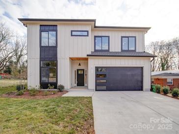 Modern two-story home with a clean white facade, black window frames, and an attached two-car garage at 2511 Dundeen St, Charlotte, NC 28216