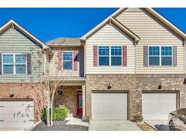 Charming townhome with a brick facade, attached garage, and well-maintained landscaping at 311 Kennebel Pl, Fort Mill, SC 29715