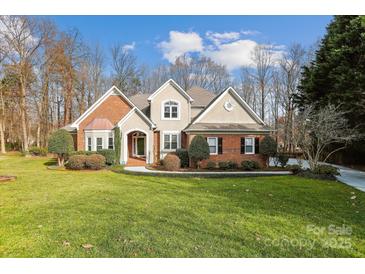 Charming brick home with manicured lawn and mature landscaping at 3536 Wylie Meadow Ln, Charlotte, NC 28269