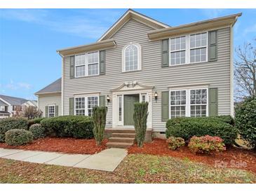 Charming two-story home featuring green shutters, mature landscaping, and a welcoming entrance at 609 Sunset Point Dr, Rock Hill, SC 29732
