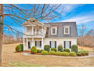 Charming two-story home featuring a cozy front porch and a second-story balcony at 662 Georgie St, Troutman, NC 28166