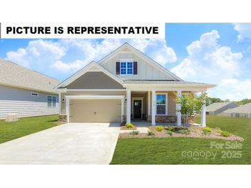 Charming single-Gathering home featuring a welcoming front porch and attached two-car garage, beautiful landscape, and nice curb appeal at 111 Noah Ln, Troutman, NC 28166