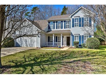 Charming two-story home featuring blue shutters, a front porch, and a well-maintained lawn on a sunny day at 3620 Cole Mill Rd, Charlotte, NC 28270