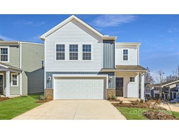 Charming two-story home with a white garage door, classic windows, and a manicured lawn at 5336 Small St, Catawba, NC 28609