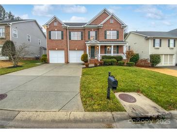 Charming brick two-story home with attached two-car garage and well-manicured front lawn at 6409 Chadwell Ct, Fort Mill, SC 29707