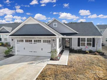 Charming single-story home boasts a well-manicured lawn, attached two-car garage, and inviting entryway at 730 Bonica Ct, Lancaster, SC 29720