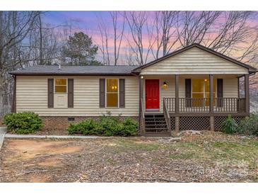 Charming single-story home features a cozy front porch and a bright red front door at 8104 Tamalpais Ct, Charlotte, NC 28215
