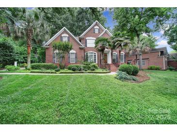 Charming brick home with a well-maintained lawn, mature trees, and inviting curb appeal at 907 Thorn Ridge Ln, Lake Wylie, SC 29710