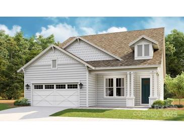 Charming single-Gathering home featuring a 2-car garage, dormer, and manicured lawn at 1043 Rabbit Hill Ln, Monroe, NC 28110