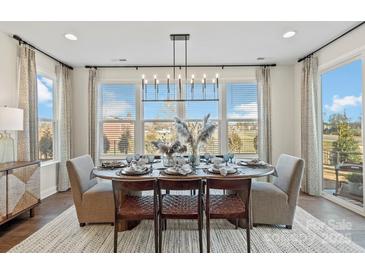 Elegant dining room featuring a large table set for a meal and large windows at 1115 Sugar Creek Rd, Indian Land, SC 29707