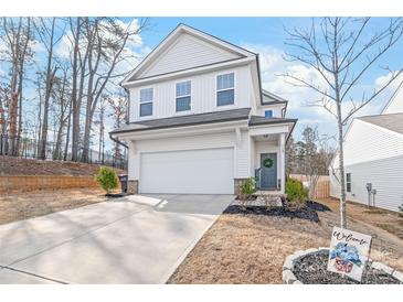 Charming two-story home featuring a welcoming entrance, attached garage, and a well-maintained front yard at 112 Buoy Ln, Statesville, NC 28677