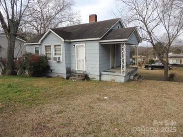 Exterior view of a single-story home with a covered porch and mature trees at 146 Loomis St, Chester, SC 29706