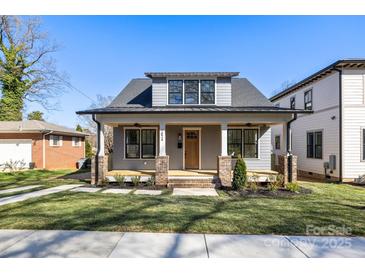 Charming home featuring a cozy front porch and well-manicured lawn at 1824 Haines St, Charlotte, NC 28216