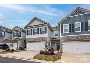 Charming townhomes featuring stone accents, two-car garages, and well-maintained landscaping at 4242 Plumeria Way, Fort Mill, SC 29707