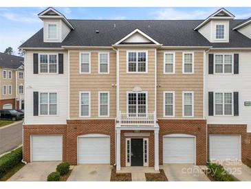 Attractive townhome with a black roof, brick, and stylish architectural details at 6464 Park Pond Dr # 7, Charlotte, NC 28262