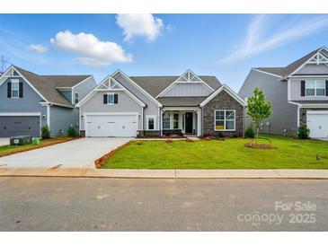 Charming single-Gathering home with a well-manicured lawn, stone accents, and an attached two-car garage at 8716 Acadia Pkwy # 596, Sherrills Ford, NC 28673