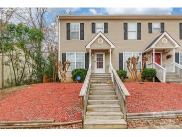 Charming townhome featuring a welcoming entrance with wooden steps and manicured landscaping at 1461 Flintwood Dr, Rock Hill, SC 29732