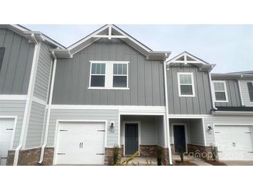 Charming two-story townhome featuring a one-car garage and modern gray siding at 1762 Braemar Village Dr, Monroe, NC 28110