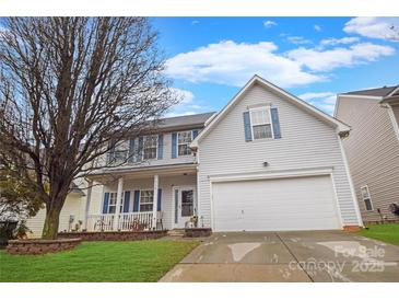 Charming two-story home with a well-manicured lawn and a covered front porch, showcasing curb appeal at 514 Galesburg Dr, Monroe, NC 28110