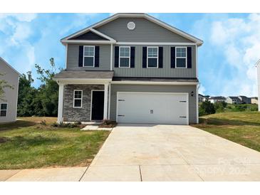 Charming two-story home featuring gray siding, black shutters, and a spacious two-car garage at 213 Lake George Dr, Shelby, NC 28152