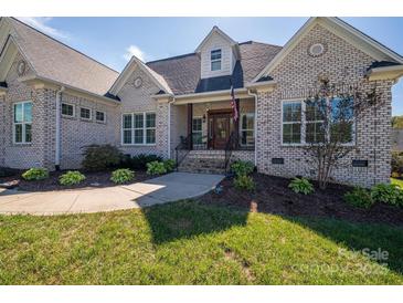 Charming brick home with a well-manicured lawn and inviting front porch, perfect for relaxing and enjoying the outdoors at 329 Wintergreen Ct, Kings Mountain, NC 28086
