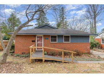 Charming single-story brick home with a ramp leading to the front entrance and blue wood accent siding at 5028 Edward St, Charlotte, NC 28213