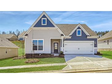 Charming single-story home with blue and gray siding, a two-car garage, and a well-manicured lawn at 5944 Oak Branch Cir, Maiden, NC 28650