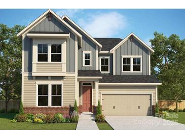 Charming two-story home with a mix of vertical and horizontal siding and a two car garage at 11205 Shreveport Dr, Huntersville, NC