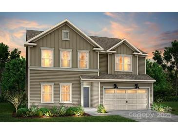 Two-story home featuring a two-car garage, neutral siding, and welcoming landscaping at 12025 Grinstead Ln # 299, Charlotte, NC 28278