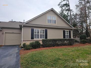 Charming single-story home with manicured lawn and neutral siding, showcasing curb appeal and a welcoming facade at 2656 Polo Club Blvd, Matthews, NC 28105
