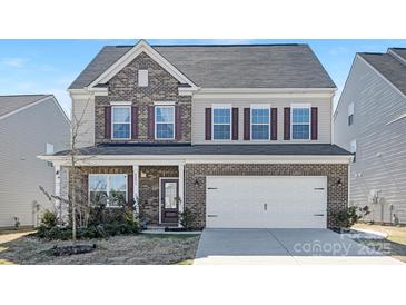 Charming two-story home with brick accents, a two-car garage, and a well-manicured front yard at 4253 Spadefoot Ct, Lancaster, SC 29720