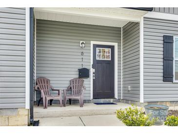 Cozy front porch featuring two chairs and attractive gray siding at 611 N York St, Gastonia, NC 28052