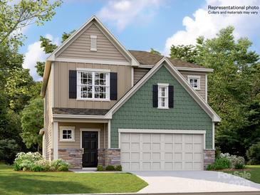 Two-story home featuring a two-car garage, stone accents, and a mix of vertical and shingle-style siding at 6271 Fairfax Ct, Maiden, NC 28650
